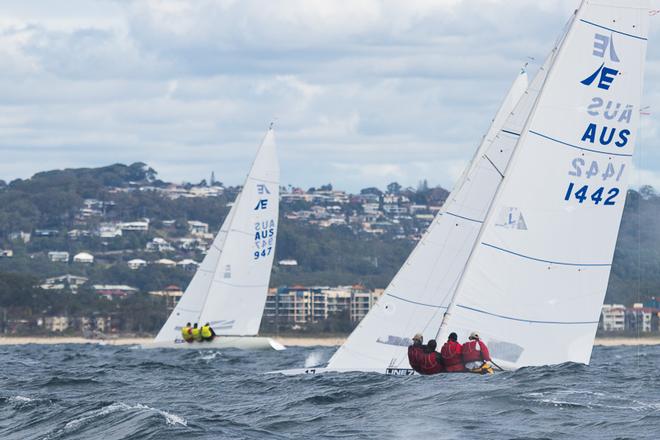 The yellow jerseys of Magpie in against the beach, with Iron Lotus in behind one of the many waves on offer today. - 2017 Etchells Australasian Championship ©  Alex McKinnon Photography http://www.alexmckinnonphotography.com